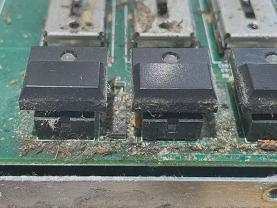 A small portion of a circuit board, covered in tobacco