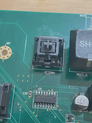 A picture of a circuit board with a new button