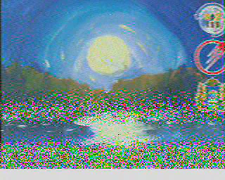 SSTV image of the moon or sun over a lake